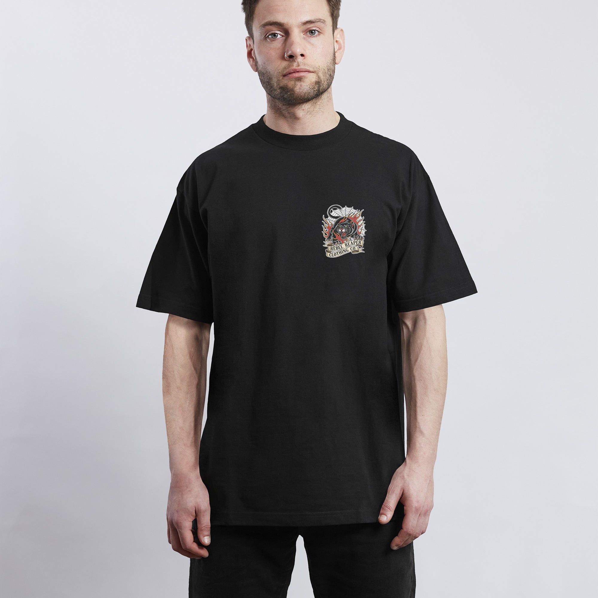 Man wearing a black t-shirt with a graphic design on a white background